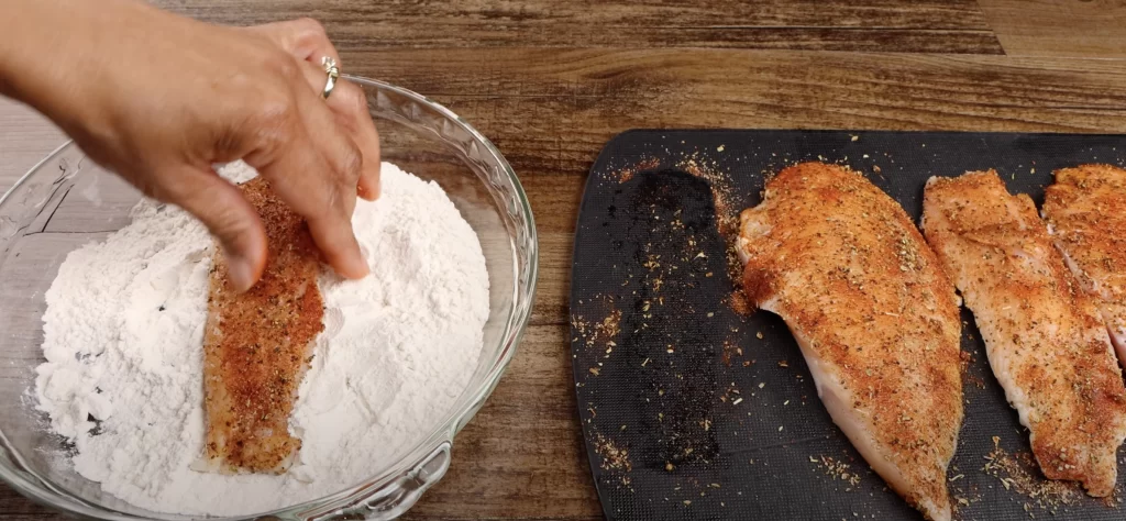 dredging the chicken in flour